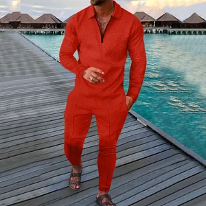 Men's vibrant red two-piece tracksuit set featuring geometric patterns on a wooden pier