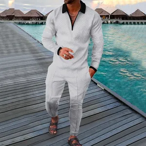 Detail view of men's white geometric print leisure two-piece set in a resort setting