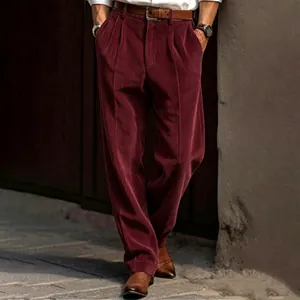 High-quality close-up showing the rich burgundy corduroy texture on men's relaxed fit trousers