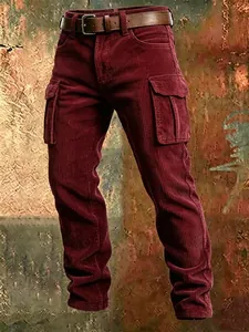 Close-up of men's burgundy corduroy cargo pants with slim fit and multi-pocket design