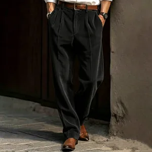 Detailed view of men's dark grey corduroy straight-leg trousers with vertical texture