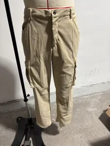 Detailed view of men's khaki corduroy cargo pants with side flap pockets on a mannequin