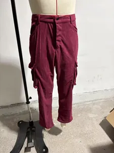Close-up of burgundy corduroy material and side pocket details on slim fit cargo pants