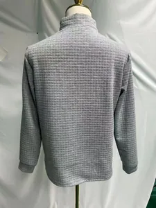 Detailed back view of a grey men's waffle knit long-sleeve polo shirt with grid texture