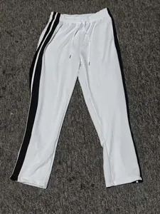 White athletic track pants with black side stripes and elastic drawstring waist