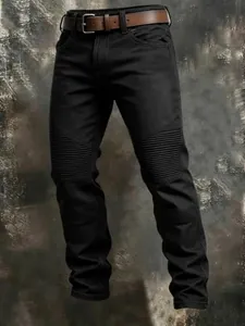 Detailed view of black cotton tactical cargo pants featuring pleated knee panels.
