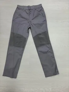Full view of grey cotton outdoor work pants featuring unique ribbed knee panel design
