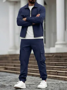 Full view of men's navy blue two-piece cargo set featuring multi-pocket jacket and pants