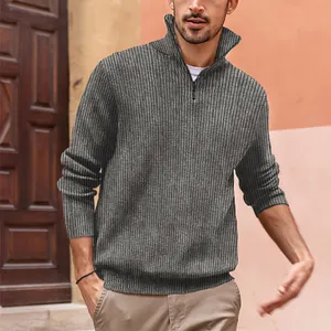 Macro detail of the grey ribbed knit fabric and half-zip collar on men's polo sweater