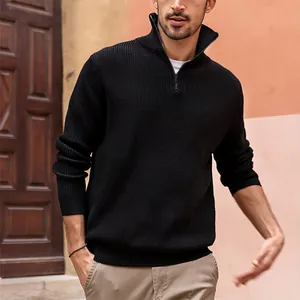 Detailed view of a men's black ribbed quarter-zip pullover sweater in an outdoor setting.