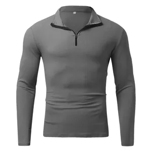 Close-up detail of grey ribbed fabric on men's long-sleeve quarter-zip polo shirt