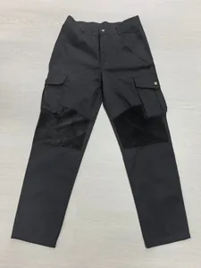 Detail view of men's black tactical cargo pants with knee reinforcement and pockets