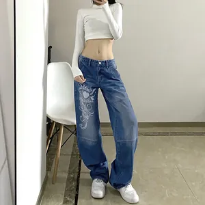 Close-up of blue baggy denim pants with white graphic heart print and relaxed fit for women.