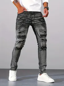 Close-up of men's silver grey distressed skinny jeans with ripped patch details