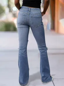 Back view of retro blue flared jeans for women with ripped details and frayed hem