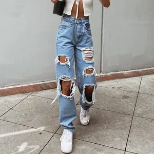 Detailed view of light blue ripped straight-leg jeans in a street style setting
