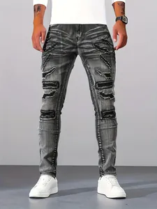 Close-up of men's silver-grey slim fit jeans with distressed ripped patch details