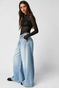 Full body view of a fashion model wearing high waist wide-leg light blue denim jeans
