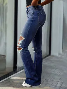 Detailed view of vintage blue distressed micro-flare jeans for women with ripped knees.