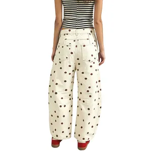 Back view of women's loose polka dot jeans with a curved leg and retro cream pattern