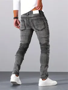 Detail view of men's silver-grey stretch skinny jeans featuring distressed wash effect.