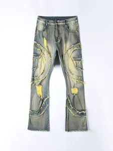 Front view of distressed flared blue jeans featuring bold yellow frayed patch details