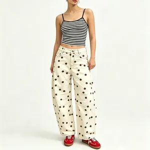 High-quality detail shot of women's loose polka dot curved leg denim trousers on model