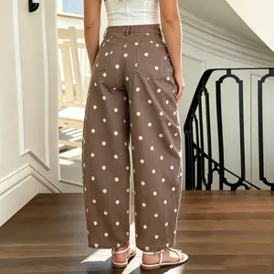 Detailed back view of women's brown loose denim pants with stylish white polka dots