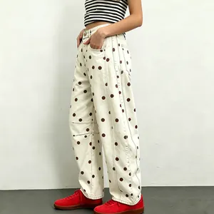 Detailed view of women's baggy polka dot jeans with a unique curved leg design and relaxed fit.