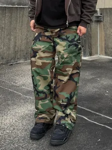Detailed look at men's loose camouflage cargo pants with a classic woodland pattern