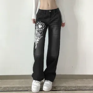 Detail view of stylish women's baggy wide-leg jeans featuring white heart print design