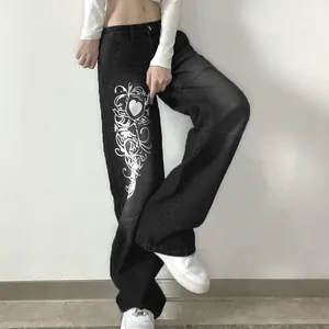 Detail view of stylish black wide-leg jeans featuring a unique white tribal heart print pattern