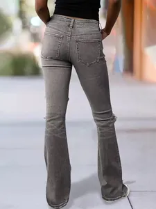 Rear view of retro gray flare jeans featuring knee distressing and frayed raw hems