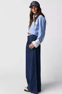 Full body shot of women's high waisted wide leg dark denim jeans with cropped shirt