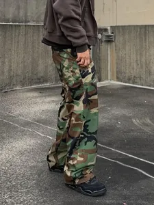 Side view of men's loose-fit camouflage cargo pants in urban streetwear setting