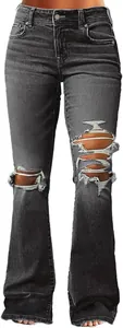 Detail view of distressed dark grey flare jeans with ripped knees and raw hem