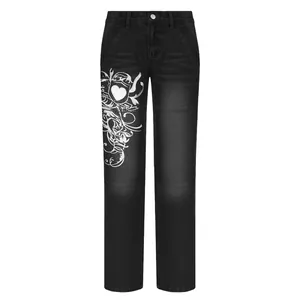 Front view of black wide-leg jeans featuring white tribal heart graphic print
