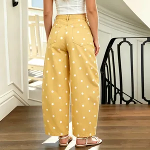 Rear view of women's yellow polka dot wide leg jeans showing fit and pocket details