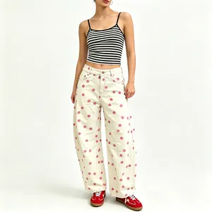 Full length view of women's loose polka dot jeans with a stylish curved wide-leg design.