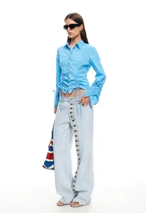 Stylish light blue wide-leg jeans with unique multi-button fly detail for women