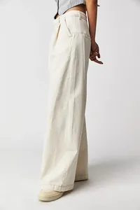 Side view detail of cream high-waisted wide-leg denim trousers for women.