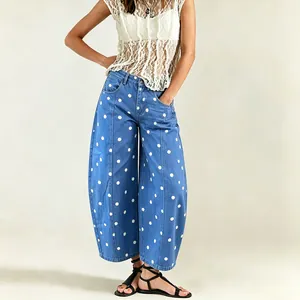 Detailed view of women's blue polka dot curved leg loose fit denim jeans