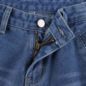 Detailed macro view showing the metal zipper and button fly of classic blue denim jeans