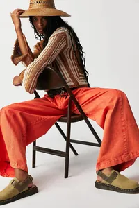 American street style wide-leg orange denim jeans paired with a bohemian knit sweater