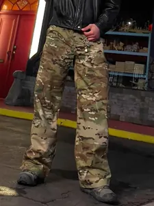 Men's loose multicam cargo pants shown in a street-style outdoor lifestyle setting