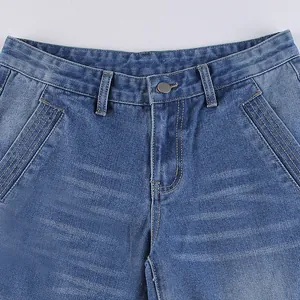 Close-up detail of blue denim jeans waist with front pockets and button closure.