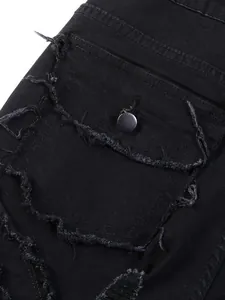 Detailed close-up of a distressed flap pocket with button on black denim jeans for men