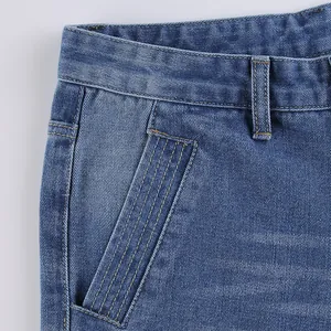 Close-up of slant pocket detail and waistband on blue wide-leg denim jeans