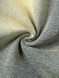 Detailed macro view of distressed vintage washed denim fabric texture with twill weave