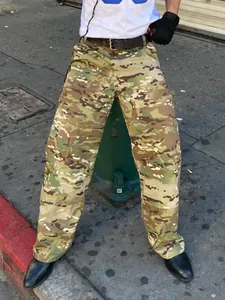 Detailed street style view of men's loose camouflage cargo pants with multicam pattern